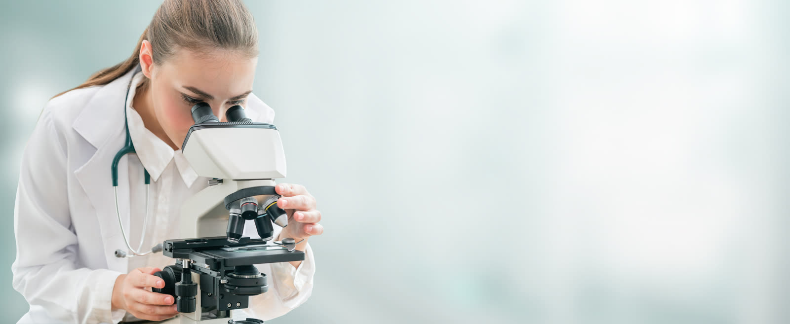Researcher using a microscope in a laboratory
